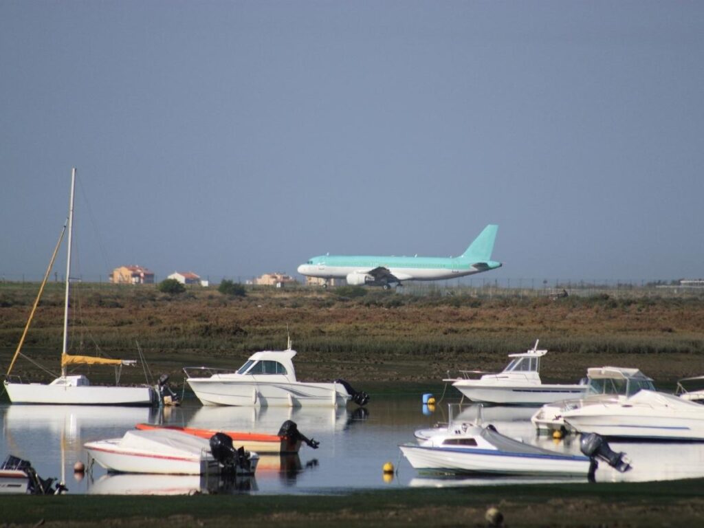 Small boat cruising the Ria Formosa lagoon near Olhão, Portugal