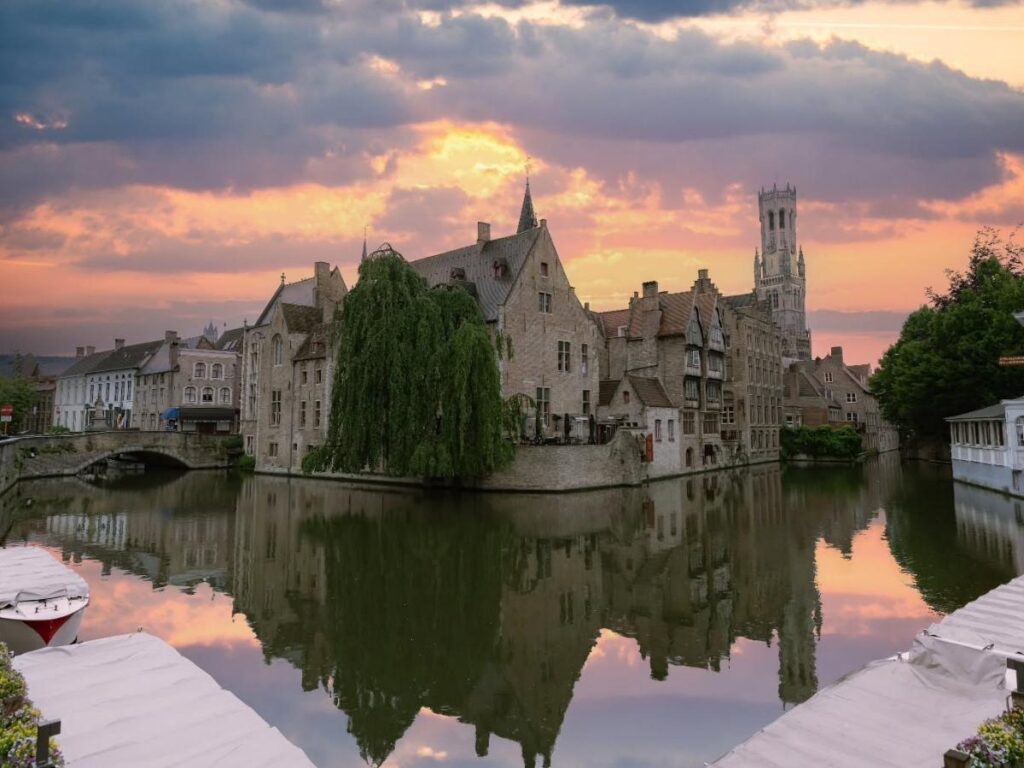 Iconic canal view of Rozenhoedkaai in Bruges with medieval buildings reflected in the water