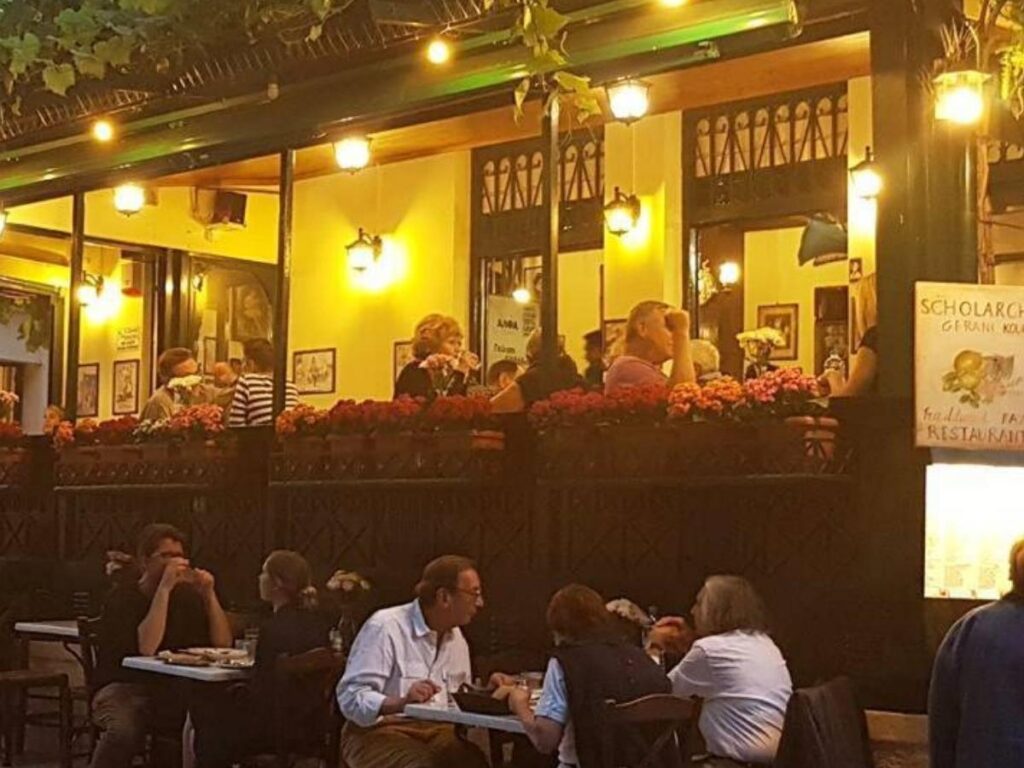 Greek taverna Scholarhio in Anafiotika, with outdoor tables shaded by vines and flowers