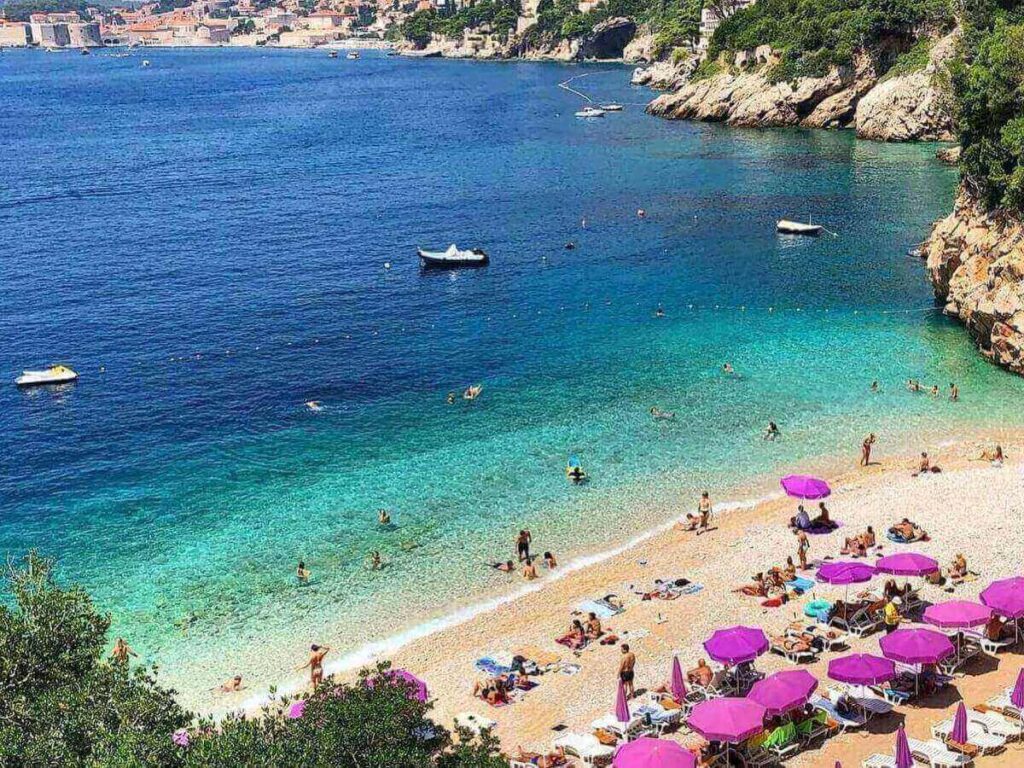 Sveti Jakov Beach tucked into a quiet bay with the Old Town visible across the water