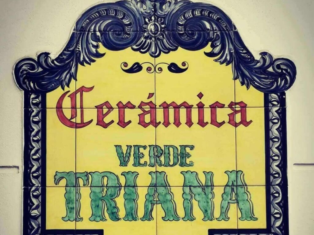 Traditional hand-painted ceramic tiles displayed in a Triana shop window