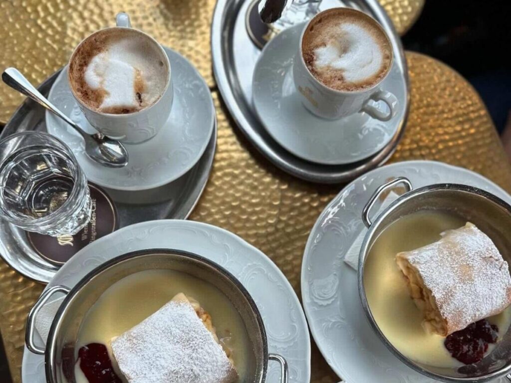 Close-up of warm Apfelstrudel dusted with powdered sugar on a plate