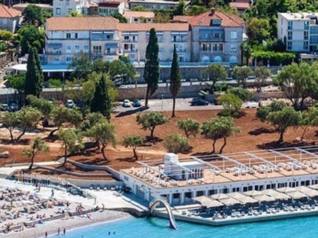 Stone façade of Boutique Hotel Villa Pattiera in Cavtat with flower-filled balconies and Mediterranean charm