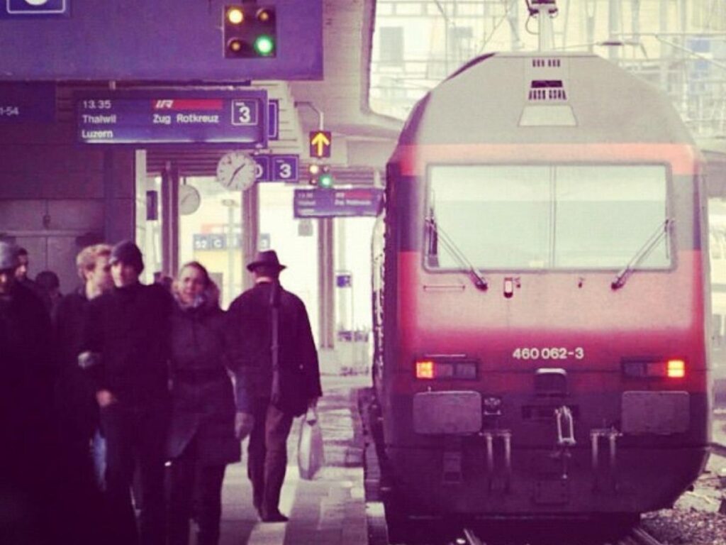 Zurich Hauptbahnhof building with tram tracks and people walking outside