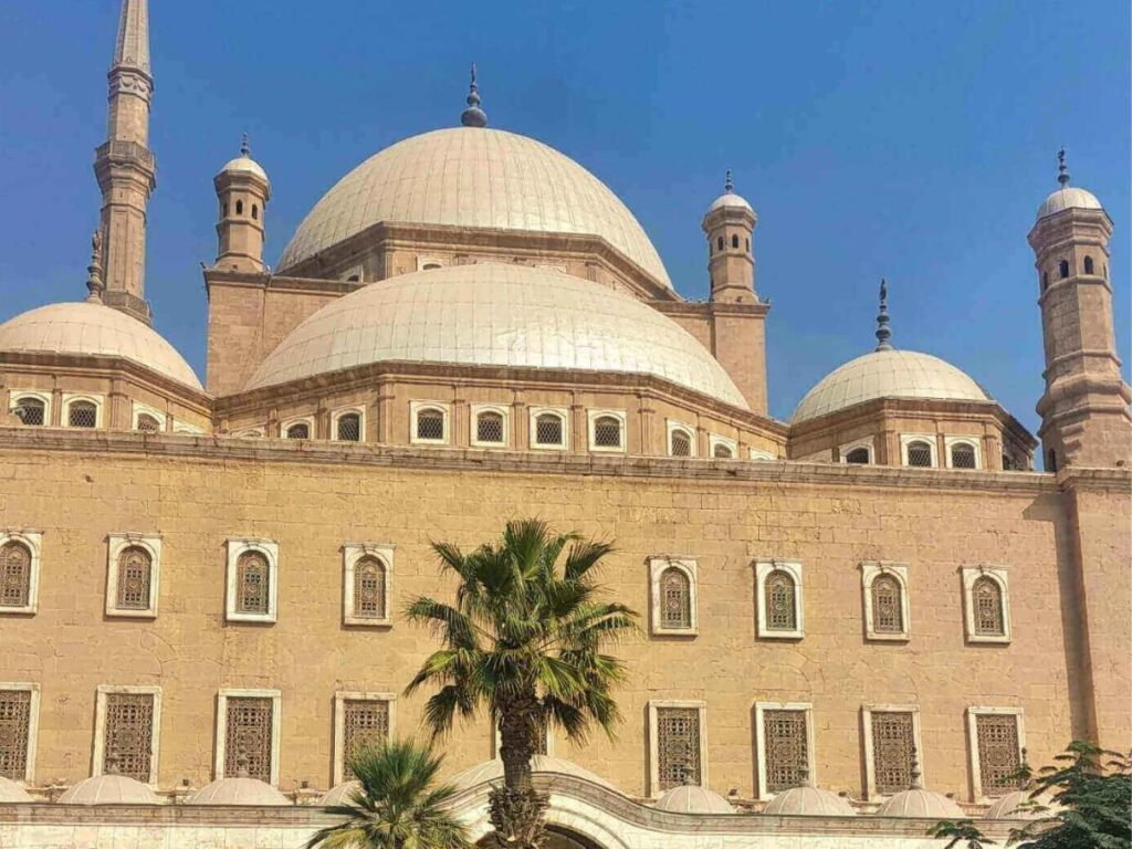 Rooftop view at dusk showing the Mezquita tower and warm-lit rooftops of Córdoba