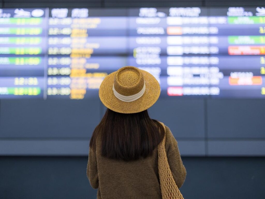 Airport departure board showing flight times and gate information