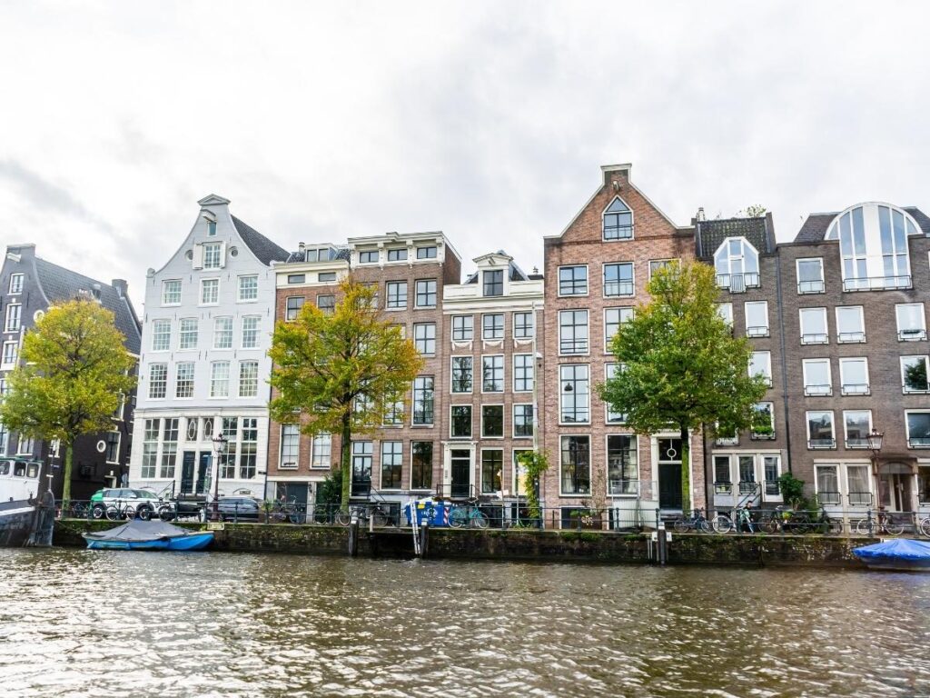 Traditional canal houses and bicycles along Amsterdam waterways in Netherlands