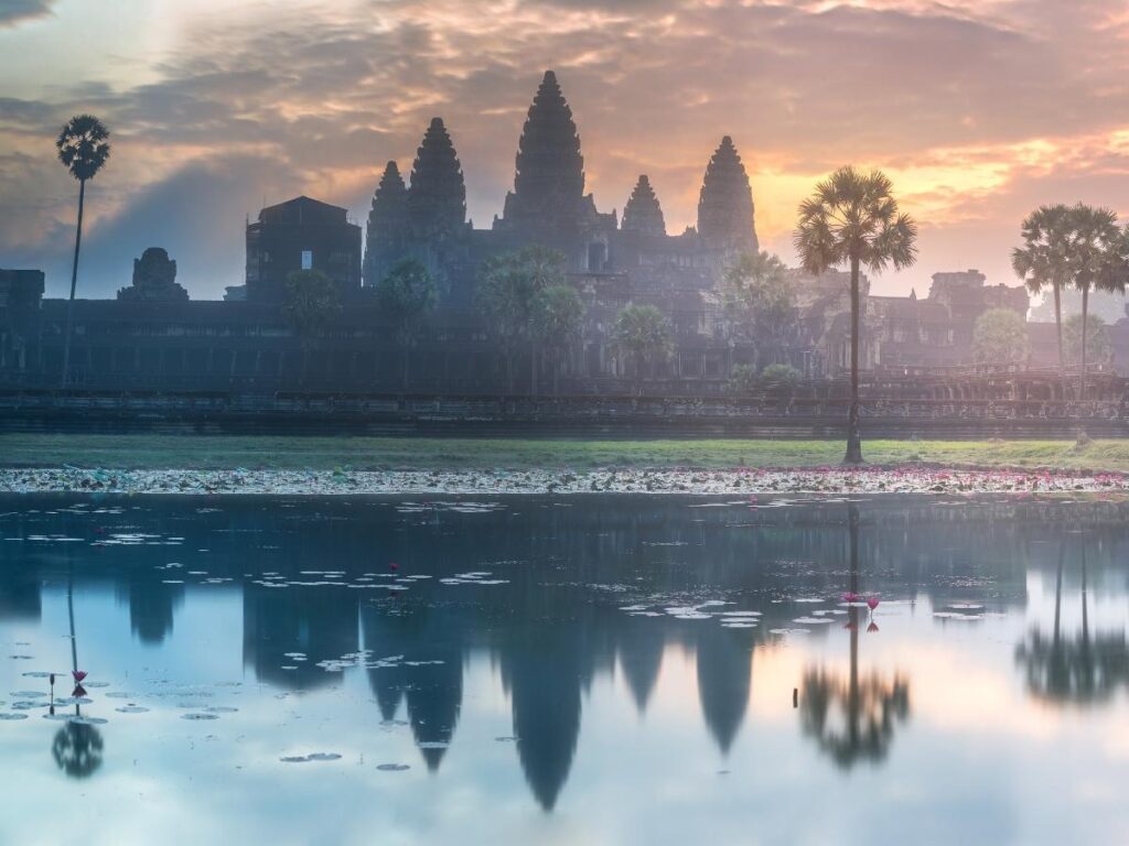 Angkor Wat temple complex reflected in water at sunrise in Siem Reap, Cambodia