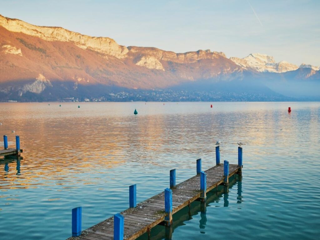 Crystal clear Lake Annecy with colorful Old Town buildings in French Alps