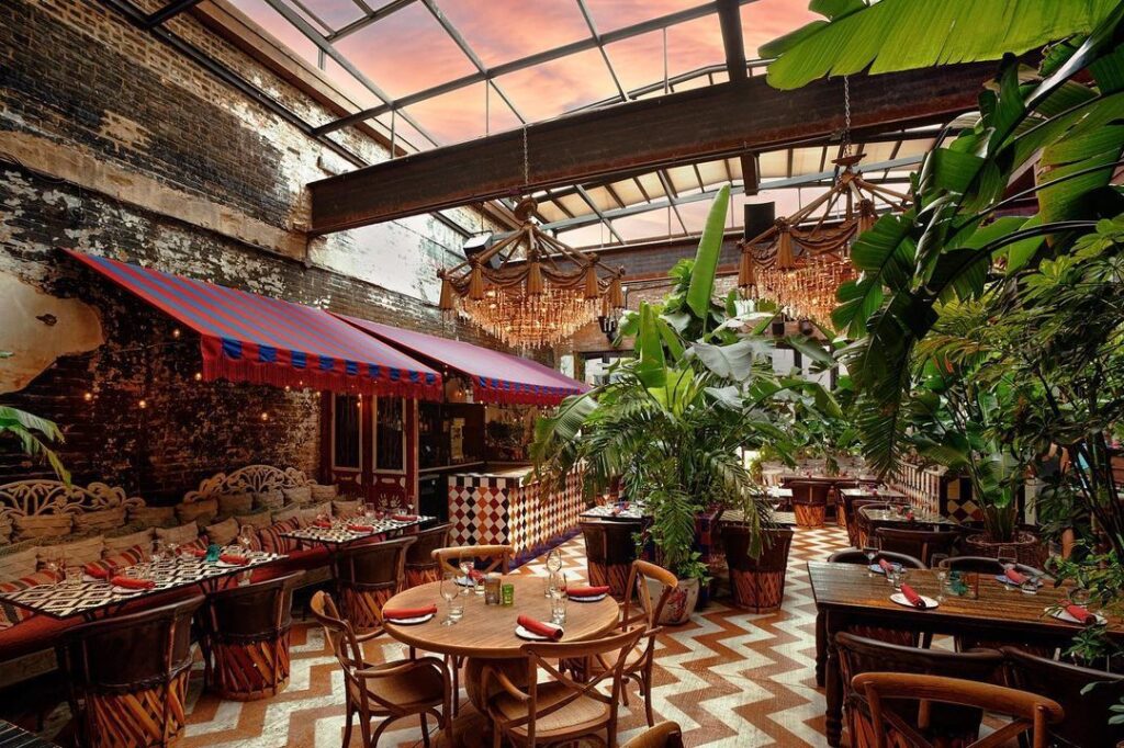 Bohemian style interior with plants and woven decor at Beatnik Chicago