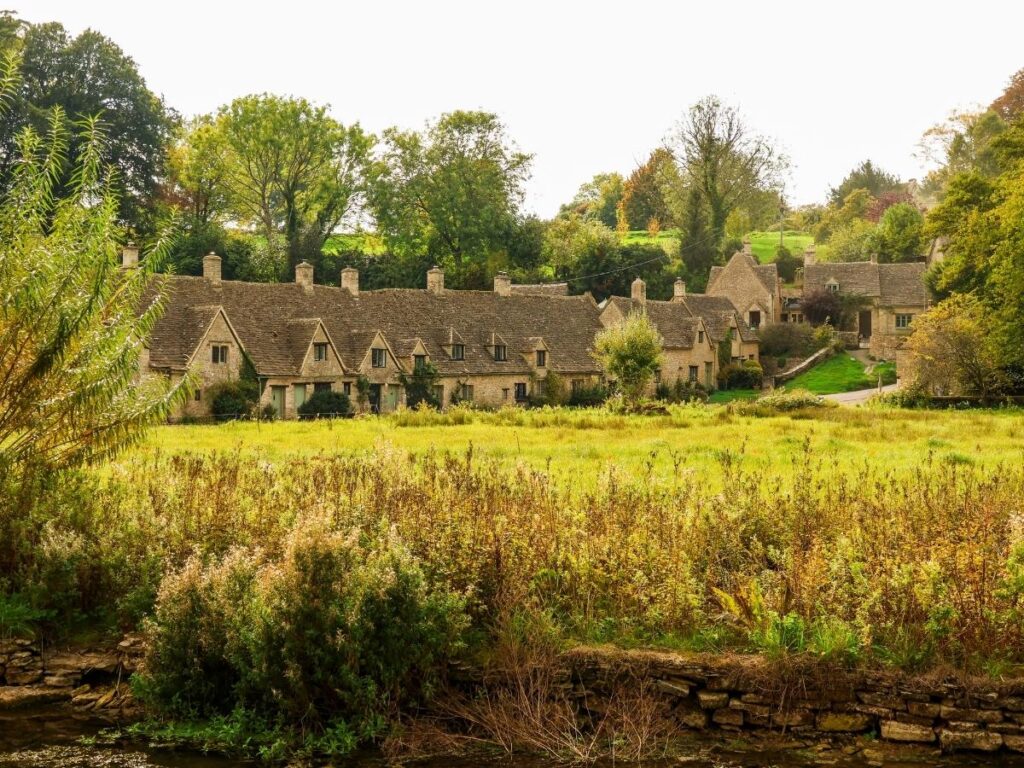 Arlington Row weavers' cottages beside River Coln in Bibury, Cotswolds
