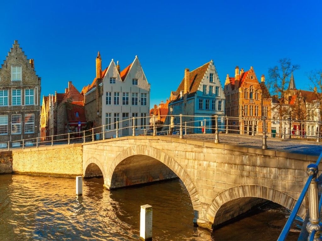 Medieval buildings and stone bridge over canal in historic Bruges, Belgium