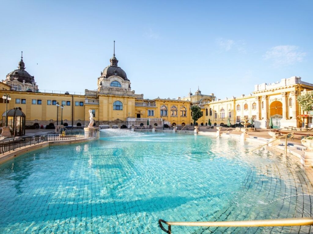 Szechenyi Thermal Bath in Budapest Hungary with people relaxing in outdoor pool