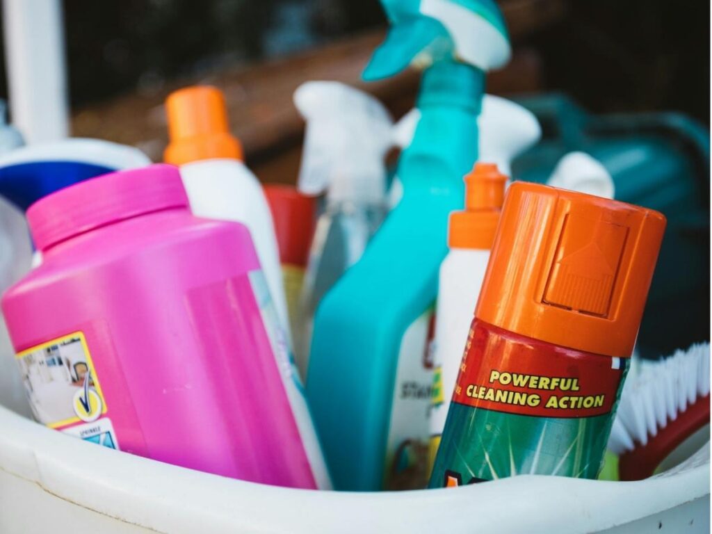 Cleaning suitcase wheels with toothbrush to remove dirt and grime