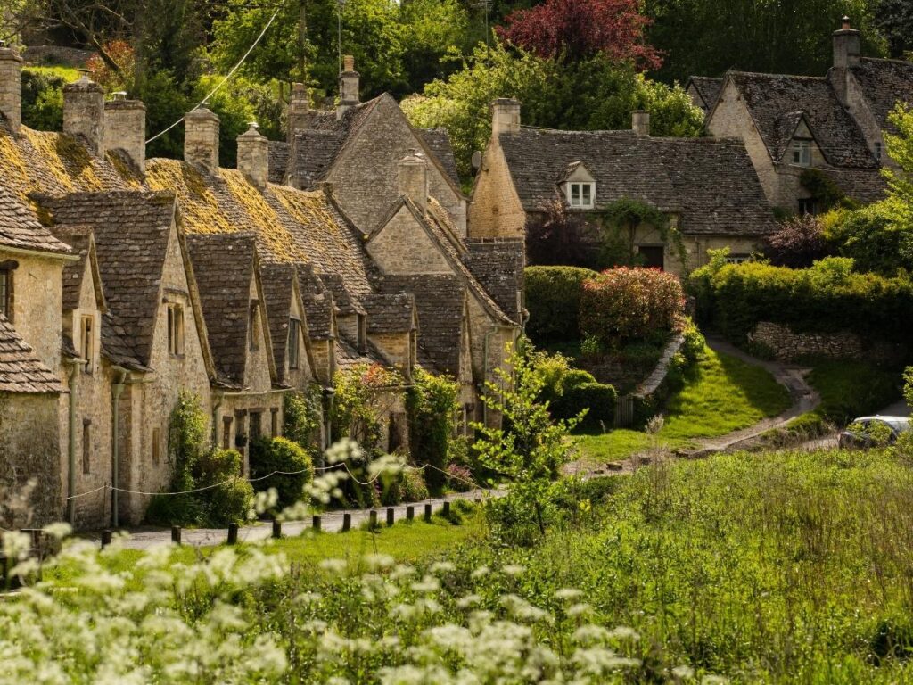 Honey-colored stone cottages at Arlington Row in Bibury village, Cotswolds, England