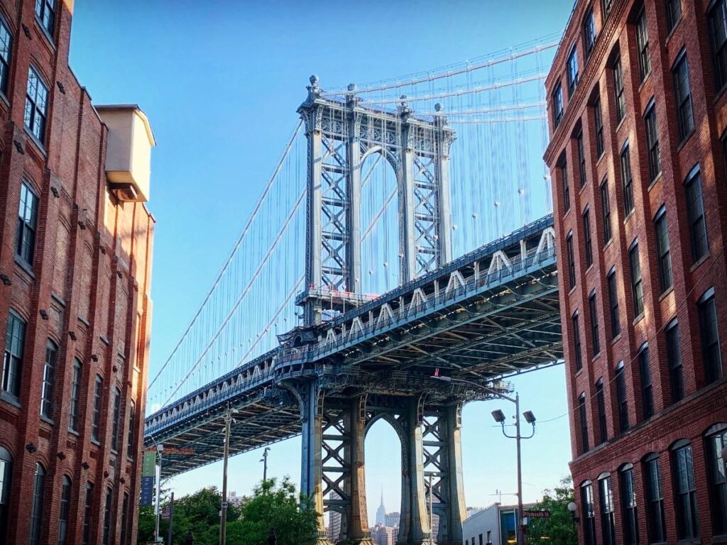Manhattan Bridge framed by buildings in DUMBO Brooklyn