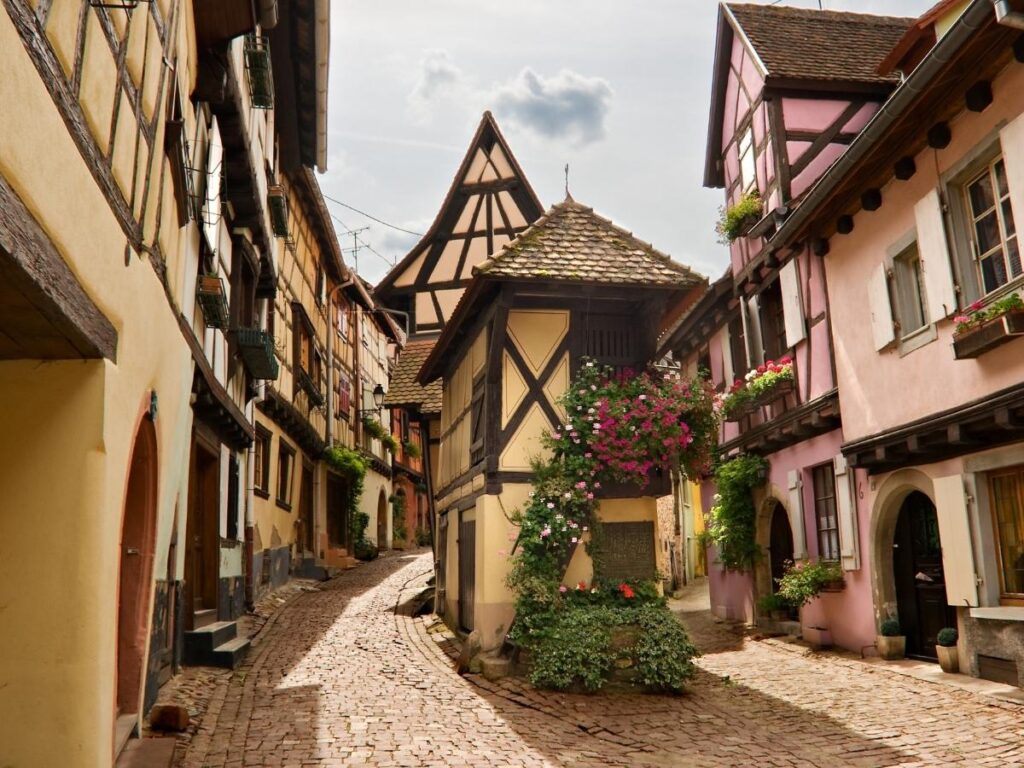 Colorful half-timbered houses in circular streets of Eguisheim Alsace wine village