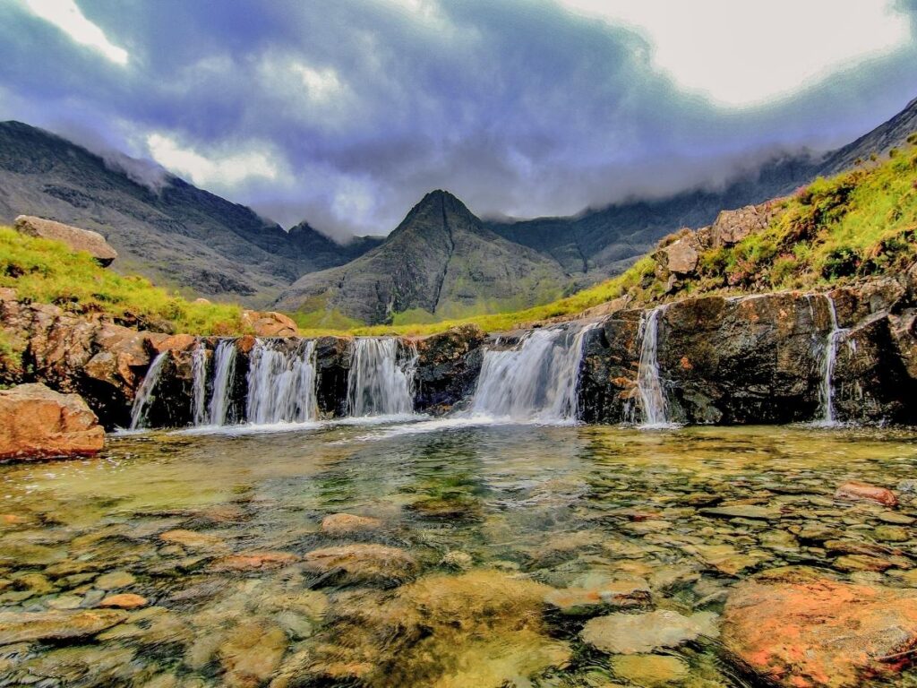 Turquoise Fairy Pools with Black Cuillin mountains in background Isle of Skye
