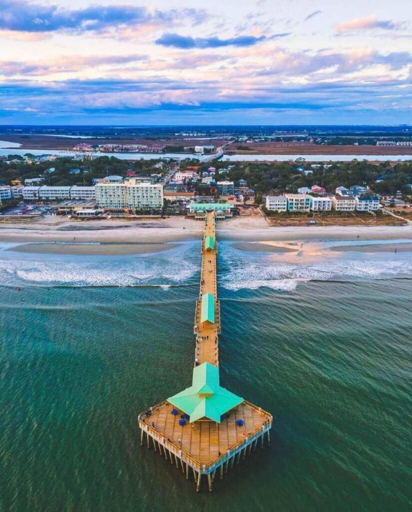 Folly Beach Pier stretching into the Atlantic Ocean at sunset