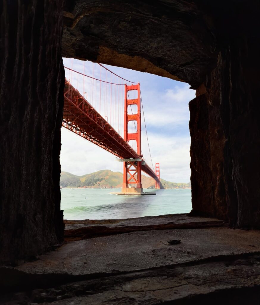 Fort Point brick fort under the Golden Gate Bridge showing dramatic bridge structure above