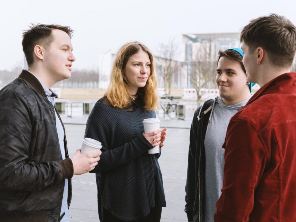 Friends having honest conversation about travel budget over coffee before trip