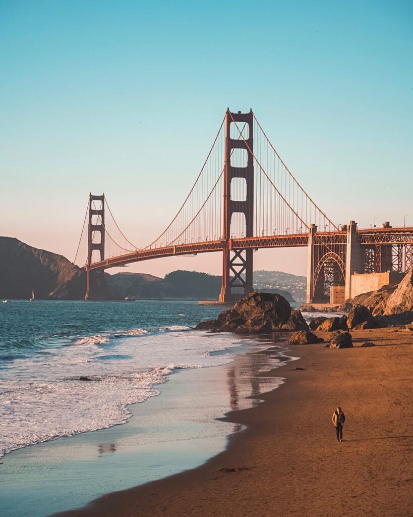 rocky shoreline at Marshall’s Beach with Golden Gate Bridge towering above