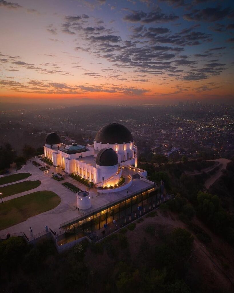 Griffith Observatory illuminated at night overlooking the Los Angeles skyline
