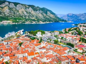 Kotor Bay Montenegro with medieval old town and mountain backdrop at sunset
