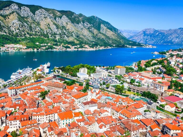 Kotor Bay Montenegro with medieval old town and mountain backdrop at sunset