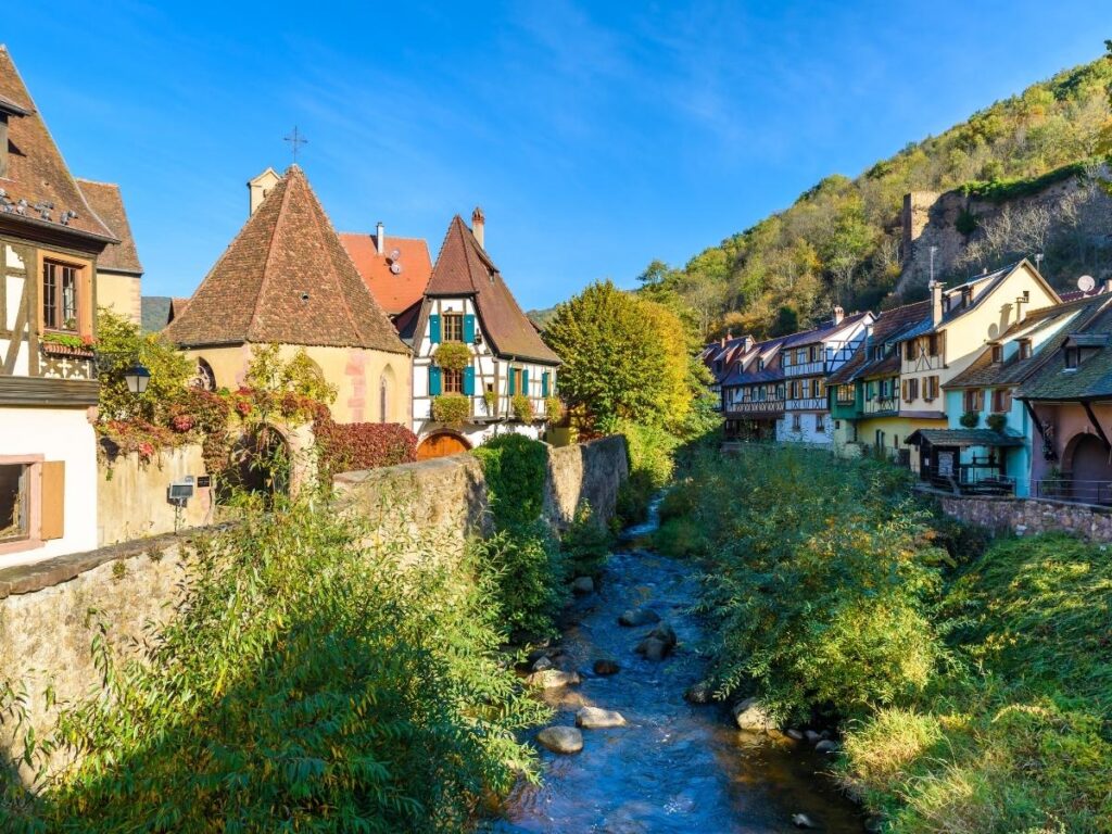 Kaysersberg village with medieval castle ruins and Weiss River in Alsace region