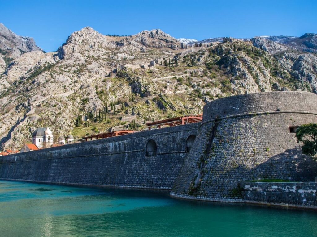 Ancient fortification walls climbing hillside above Kotor Old Town Montenegro