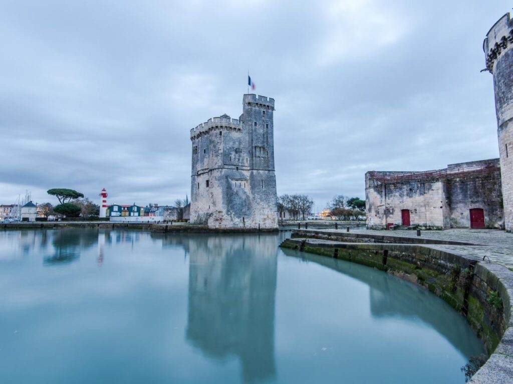 La Rochelle Old Port with historic towers and sailboats at sunset perfect for remote workers in coastal France