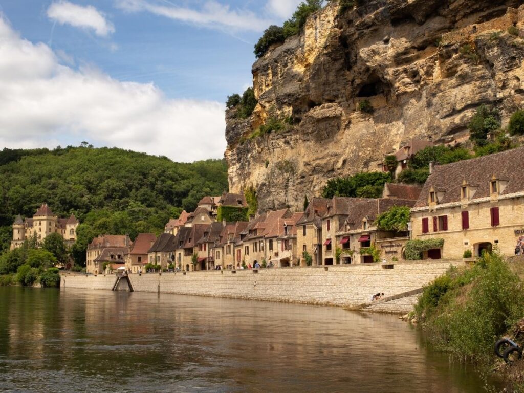 La Roque-Gageac village nestled between limestone cliffs and Dordogne River