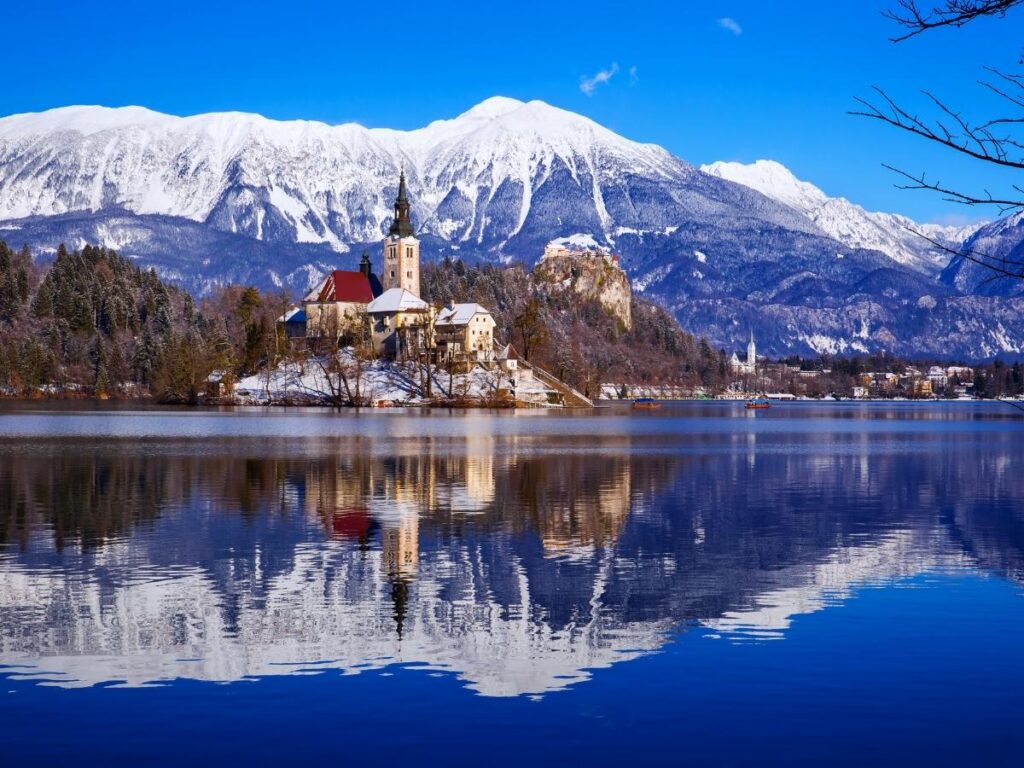 Bled Island with church in emerald lake surrounded by Julian Alps, Slovenia