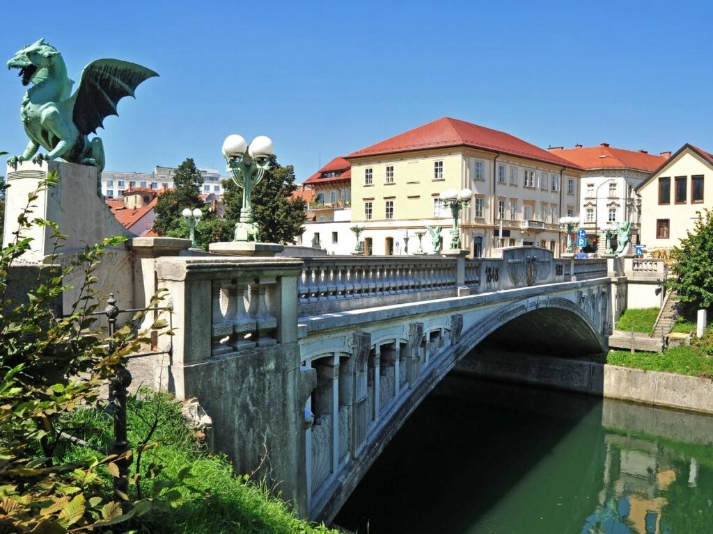 Ljubljanica River with colorful buildings and Dragon Bridge in Ljubljana Slovenia
