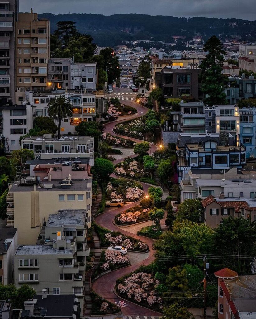 winding Lombard Street with red brick curves and landscaped flower beds