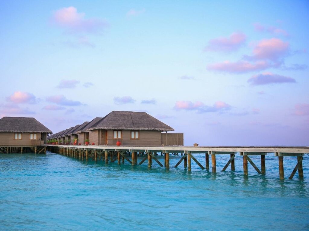 Luxury overwater villa with crystal clear turquoise lagoon in Maldives