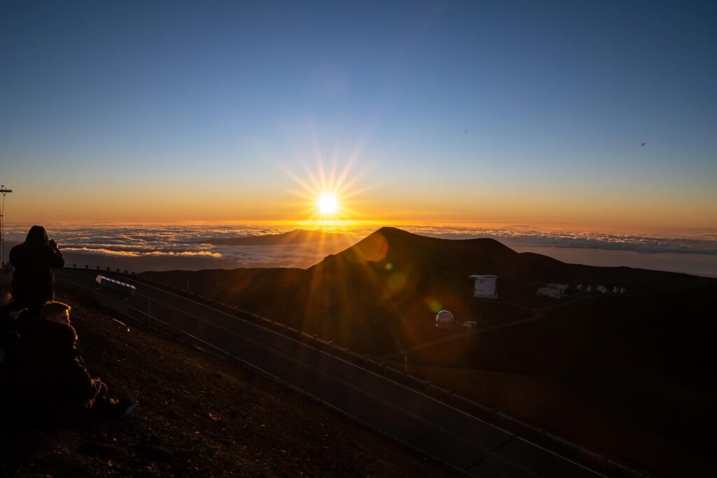 Sunset above the clouds from Mauna Kea, the final stop on a Big Island photography itinerary
