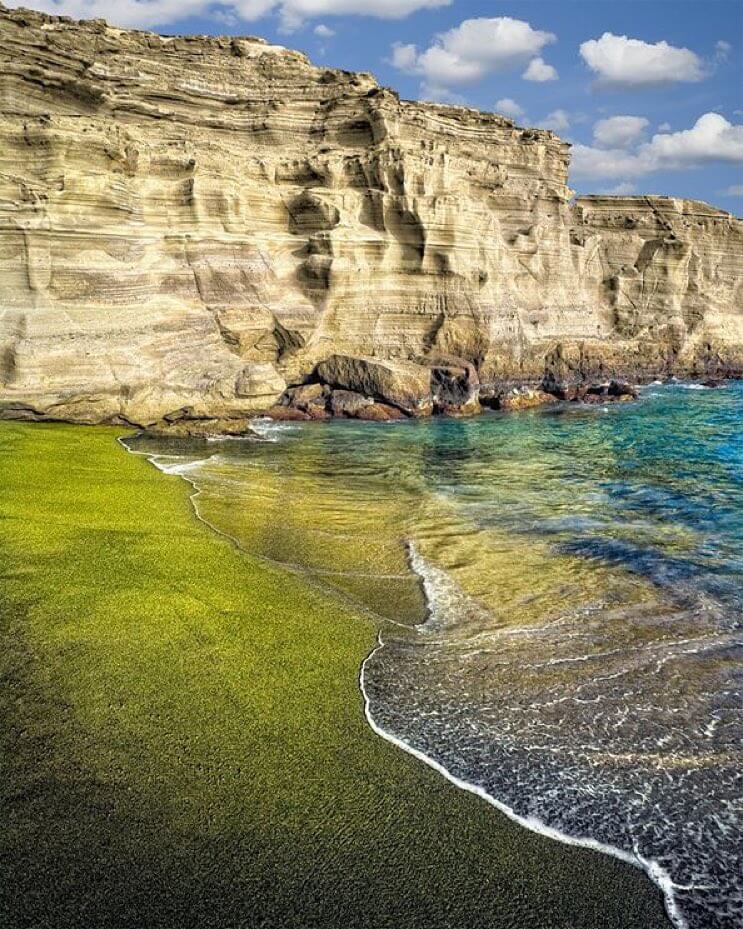 Papakōlea Green Sand Beach surrounded by volcanic cliffs on the Big Island