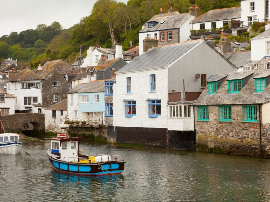 Whitewashed cottages and boats in Polperro harbor, Cornwall