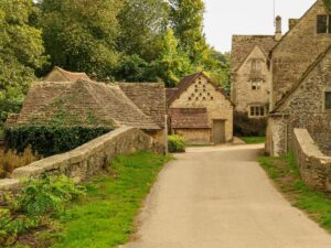 Honey-colored stone cottages in a picturesque Cotswolds village, England