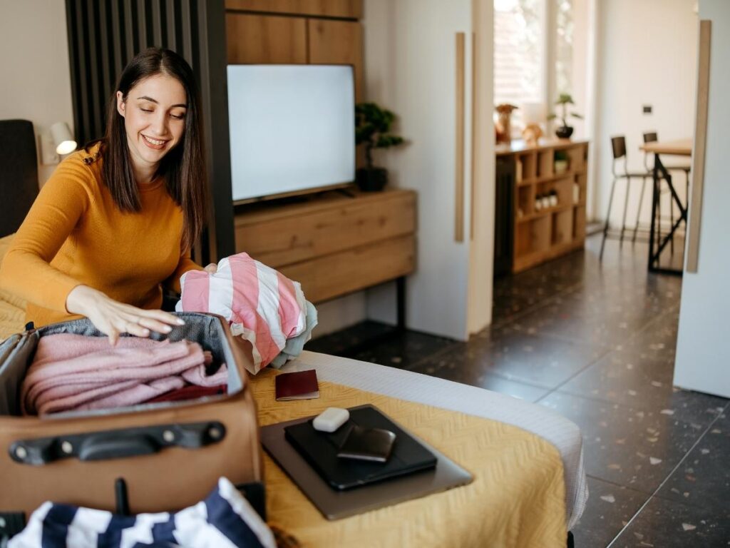 Clean suitcase stored open in well ventilated closet space