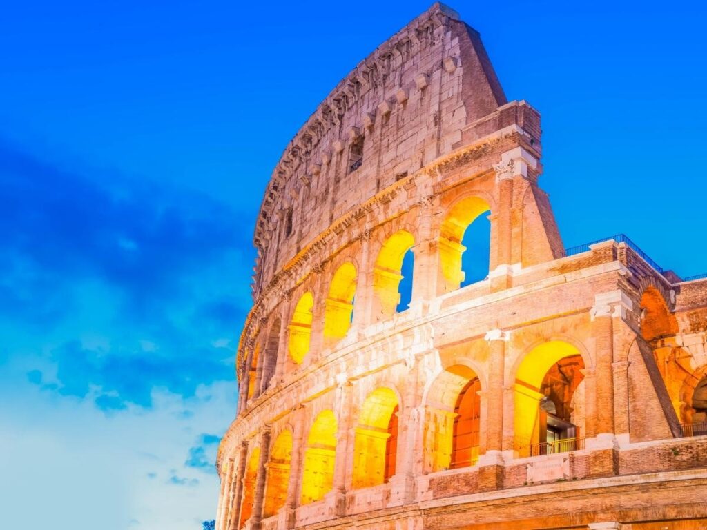 Ancient Colosseum in Rome Italy with tourists exploring historic Roman architecture