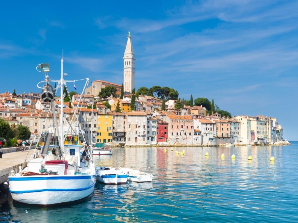 Colorful buildings cascading to harbor with St. Euphemia Church in Rovinj, Croatia