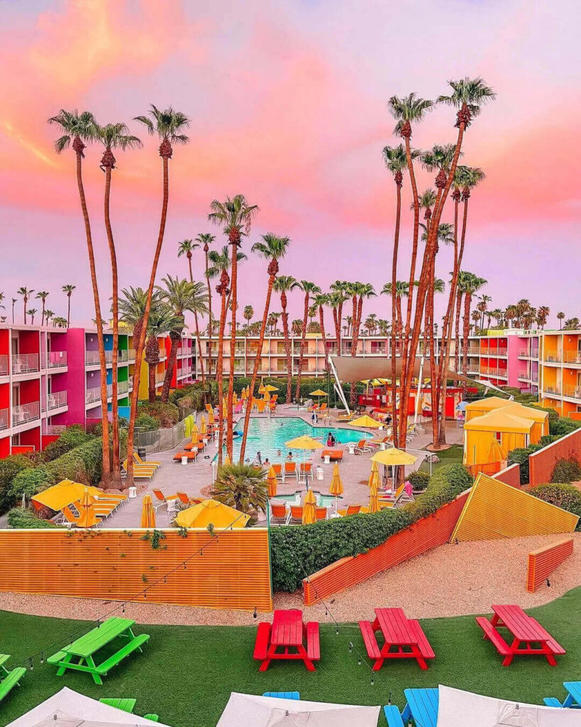 Colorful exterior of The Saguaro Palm Springs hotel with rainbow-colored walls