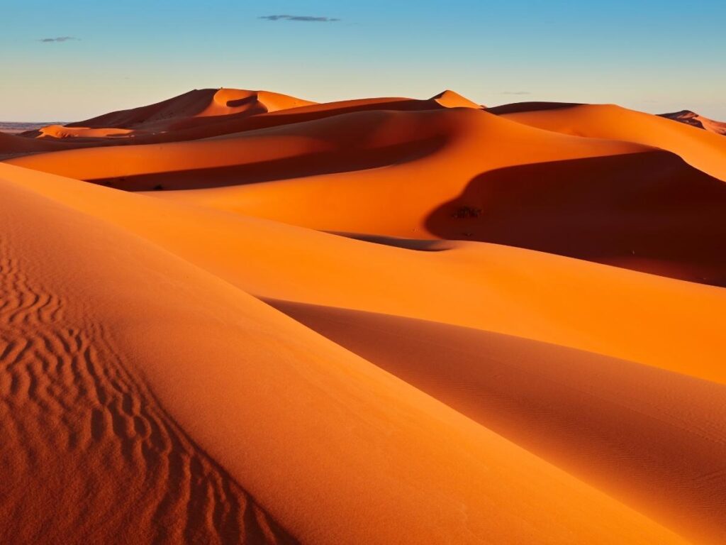Golden sand dunes at sunset in Sahara Desert Morocco