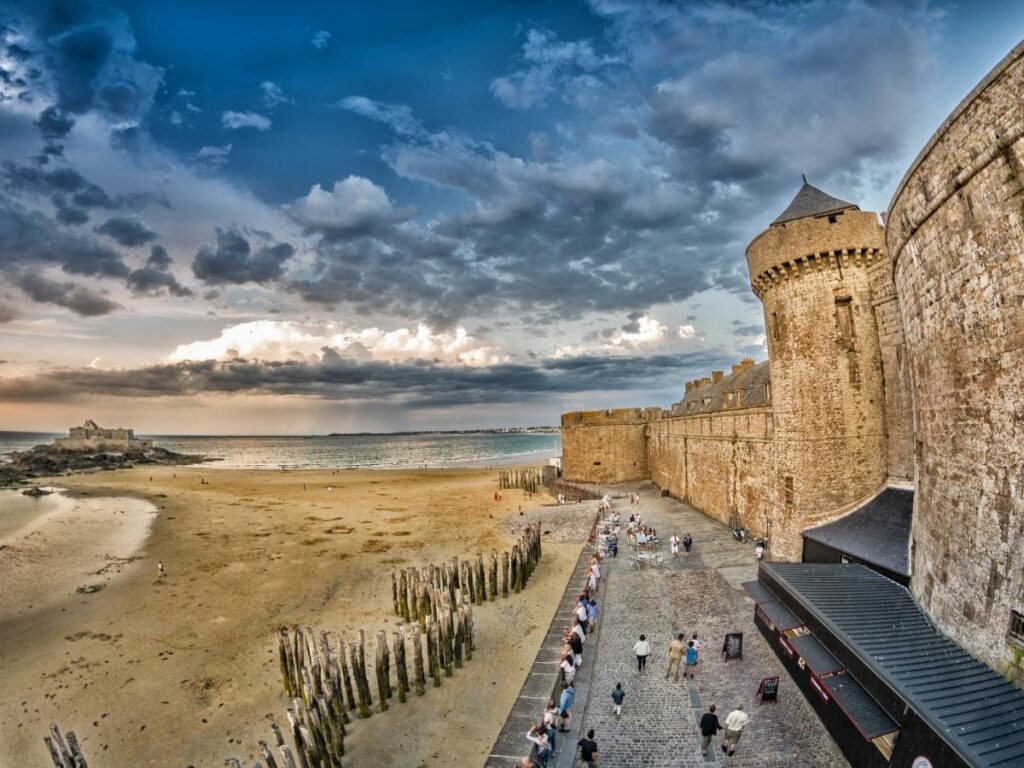 Medieval fortified walls of Saint Malo overlooking dramatic Atlantic Ocean coastline in Brittany France