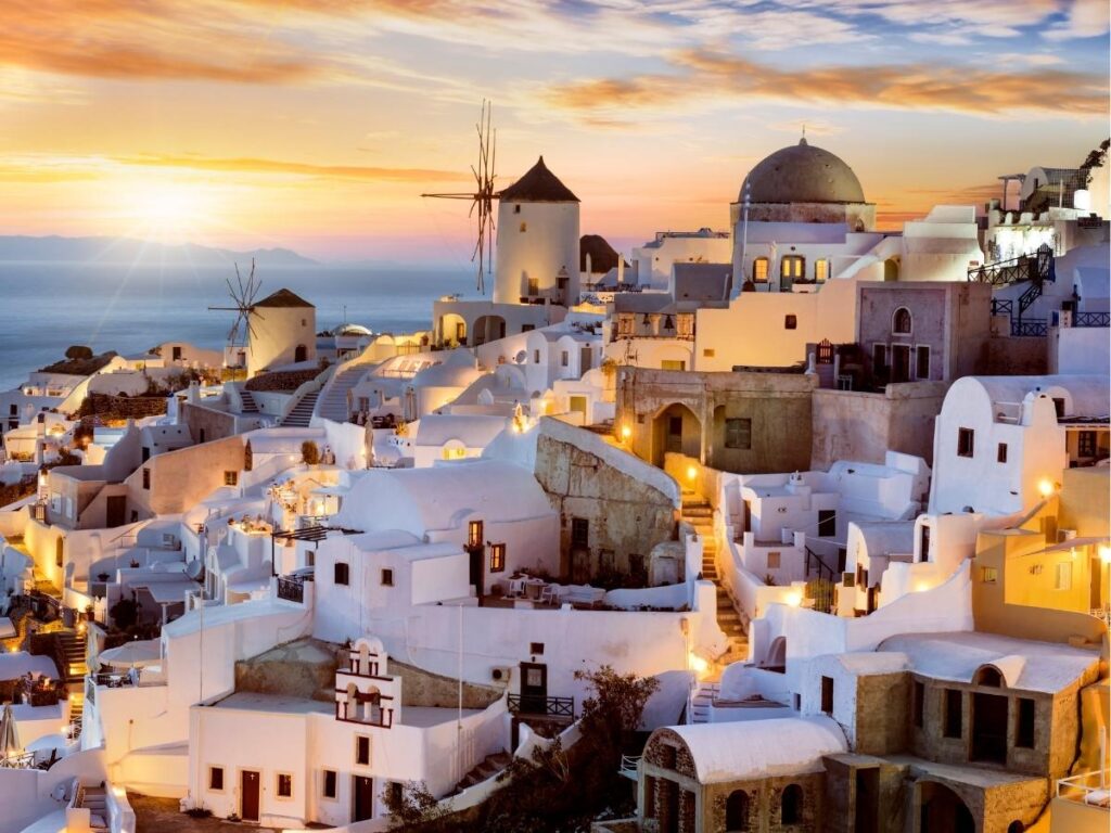White-washed buildings with blue domes overlooking the Aegean Sea in Oia, Santorini