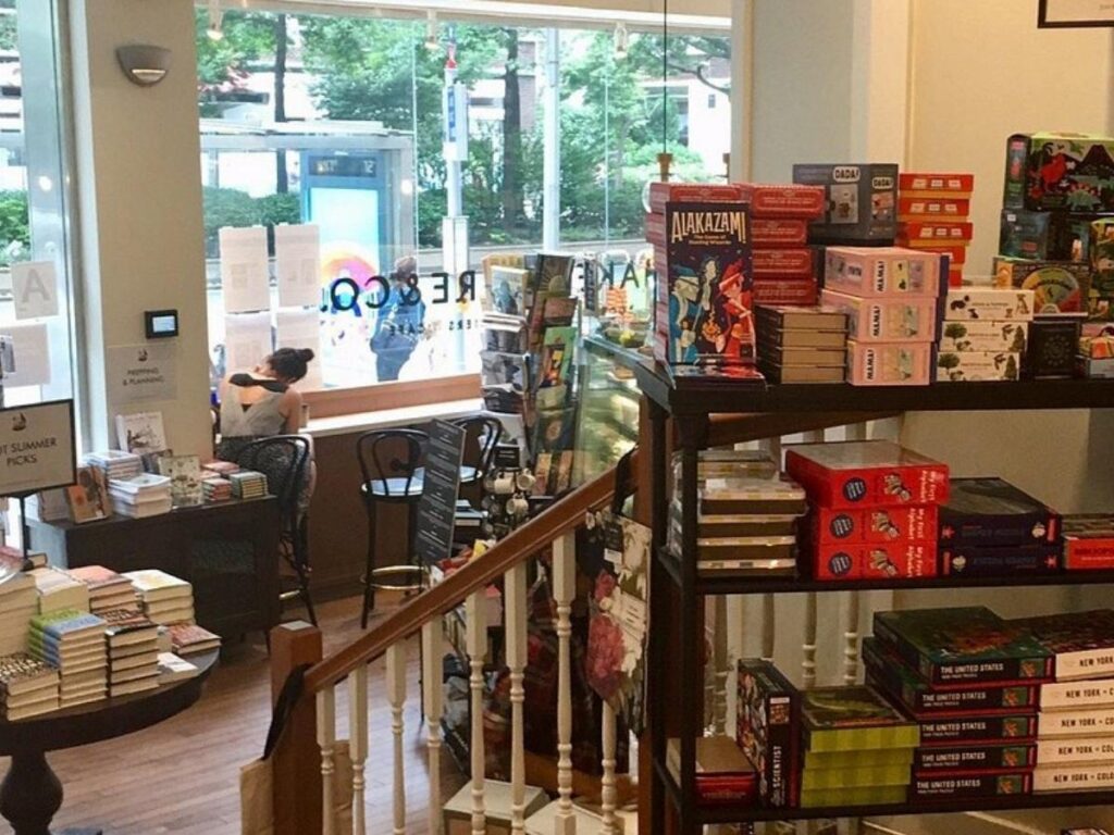 Interior of Shakespeare & Co bookstore with bookshelves and coffee shop on Upper East Side