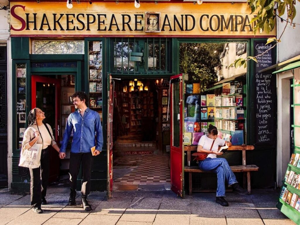 Historic English bookstore exterior with green storefront on Left Bank near Notre-Dame in Paris